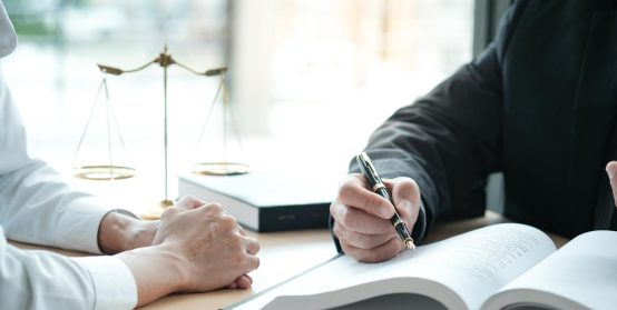 Legal counsel presents to the client a signed contract with gavel and legal law. justice and lawyer concept.